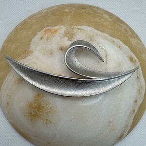 Crown Trifari vintage modernist abstract swirl silver-tone brooch.